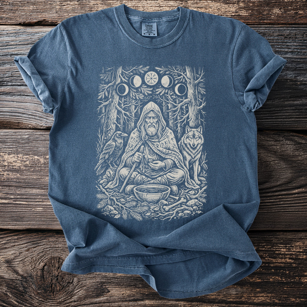 Blue t-shirt with a shaman, raven, wolf, and moon phases graphic.