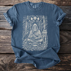 Blue t-shirt with a shaman, raven, wolf, and moon phases graphic.