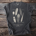 Dark t-shirt with line drawings of various bird feathers and text "The Plumage Cabinet".