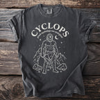 Dark t-shirt with white graphic of a cyclops and text "cyclops greek mythology one eyed giant".