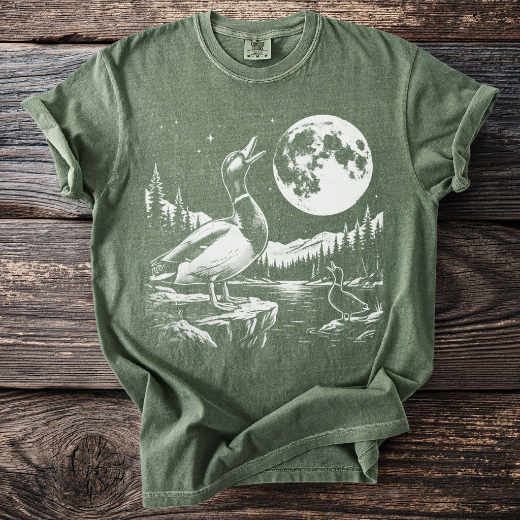 Two ducks under a full moon with a mountainous forest landscape graphic.