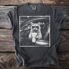 Raccoon wearing sunglasses driving a car and holding a drink.