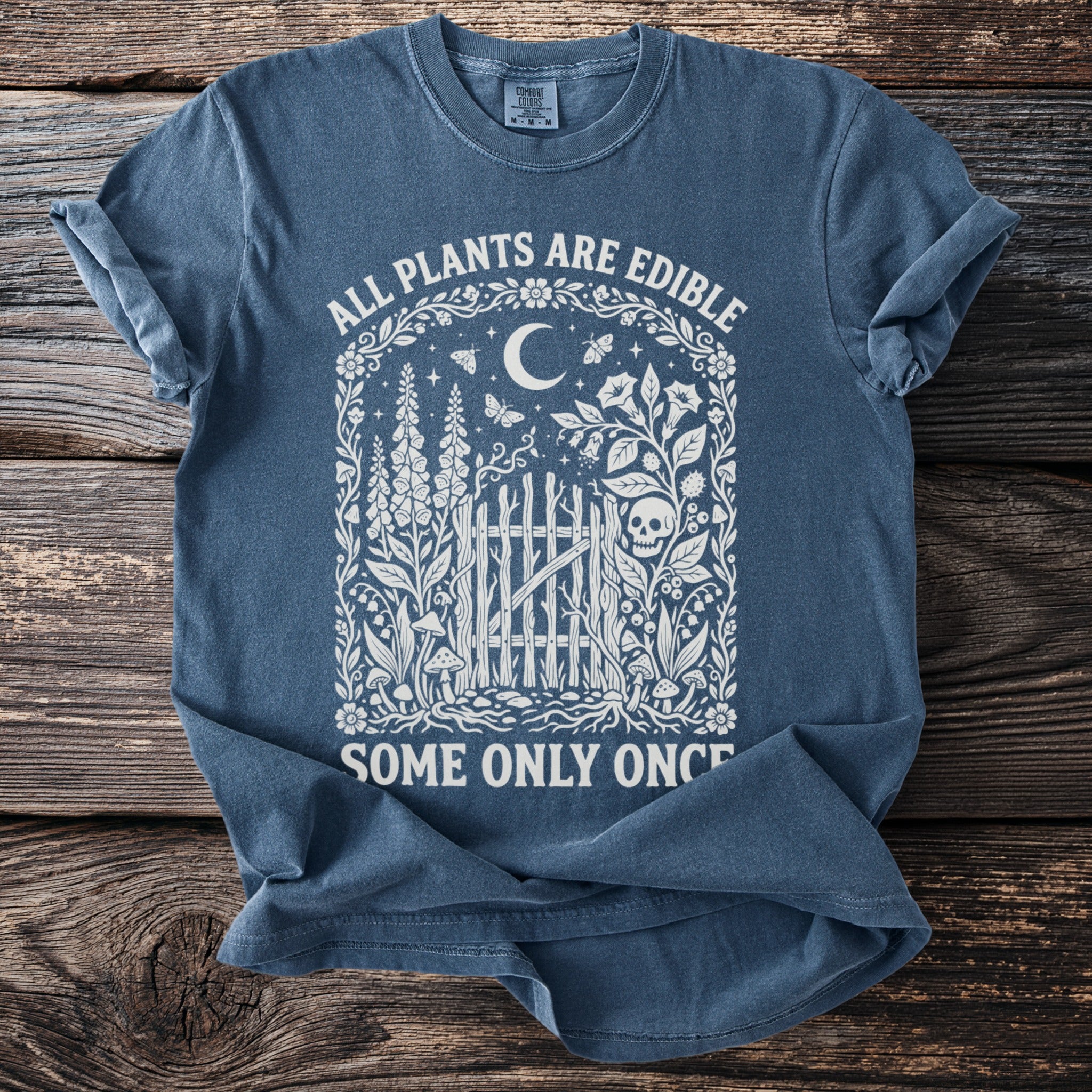 Blue t-shirt with text "All plants are edible. Some only once."