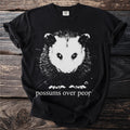 Black t-shirt with a graphic of an opossum and text "possums over people".
