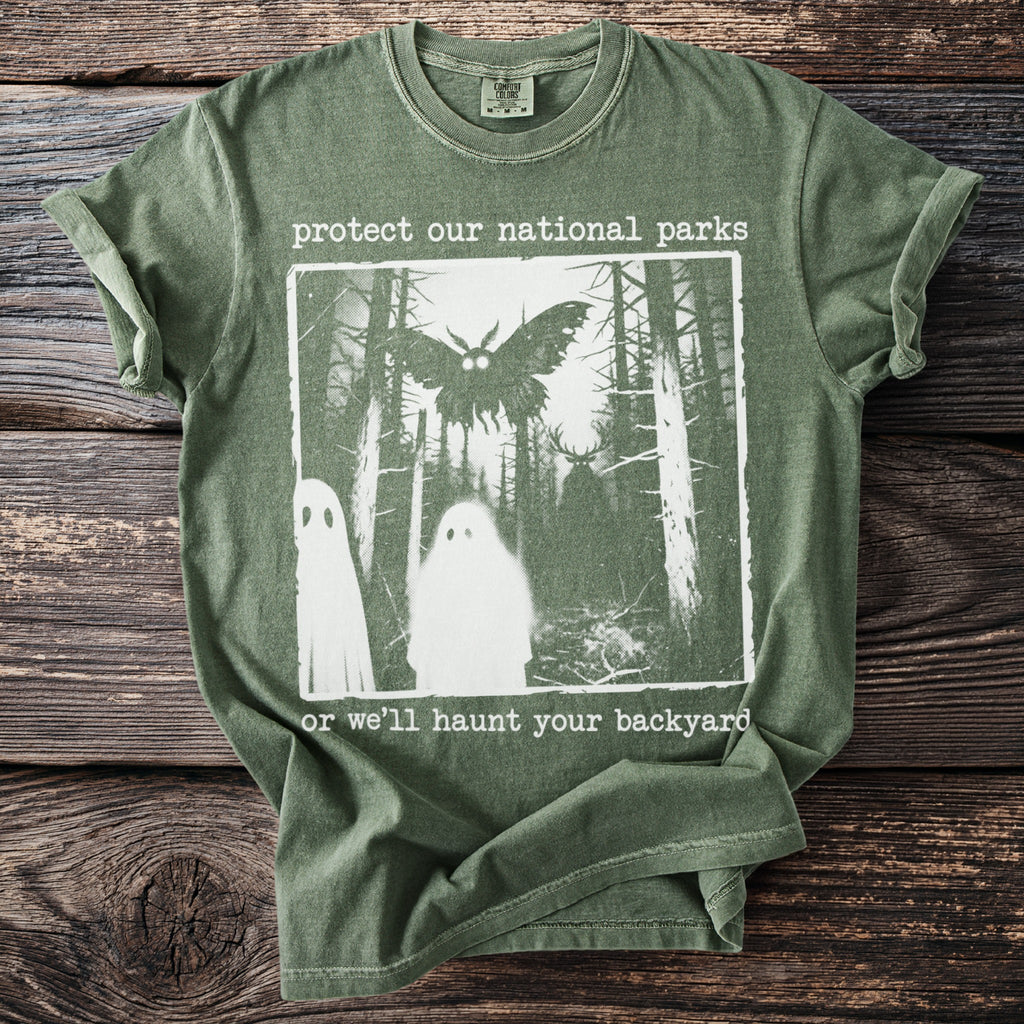 Green t-shirt with "protect our national parks" and spooky forest graphic.