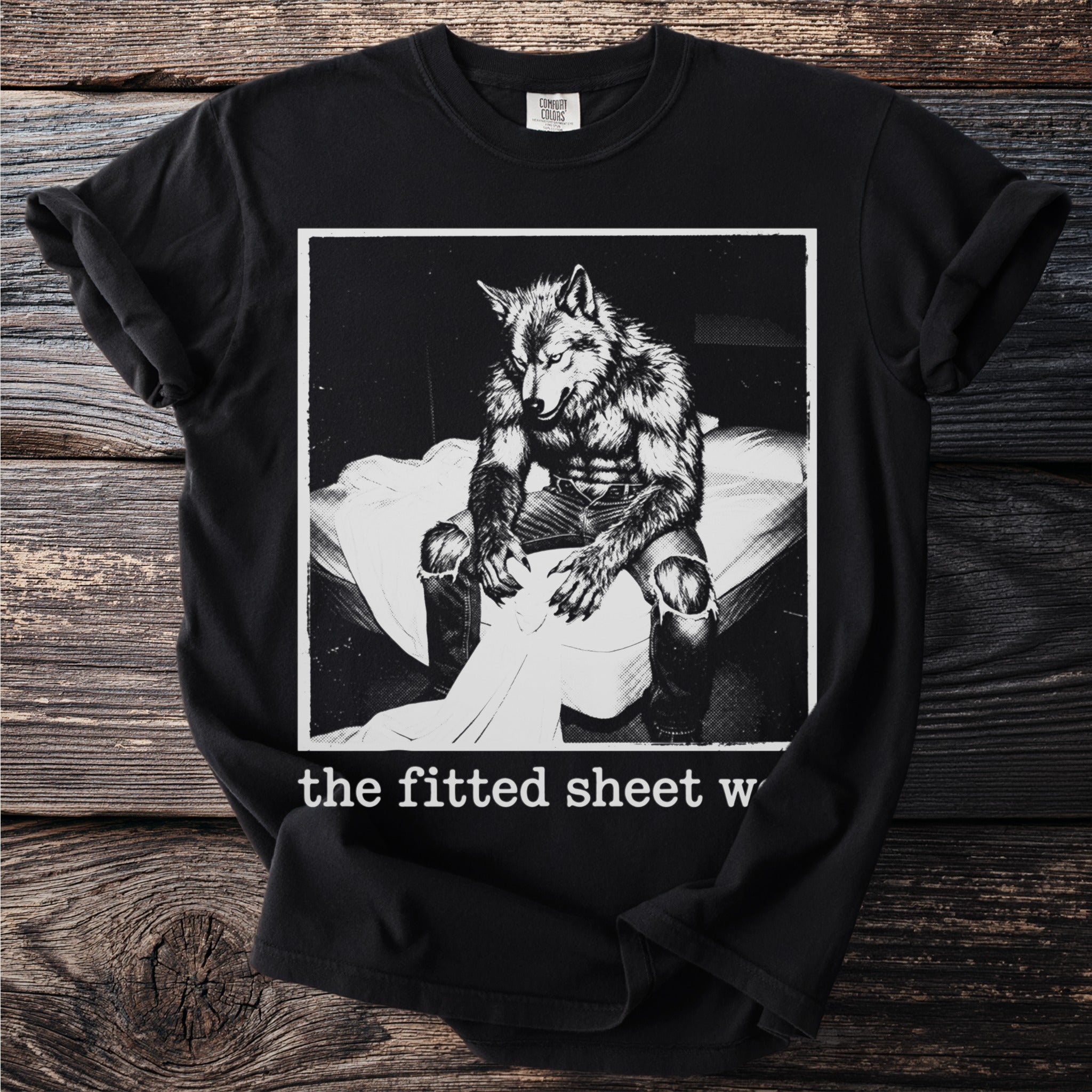 Black t-shirt with werewolf graphic and text "the fitted sheet w"