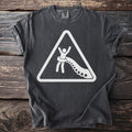 Dark gray t-shirt with a white warning sign graphic of a person being pulled by tentacles.