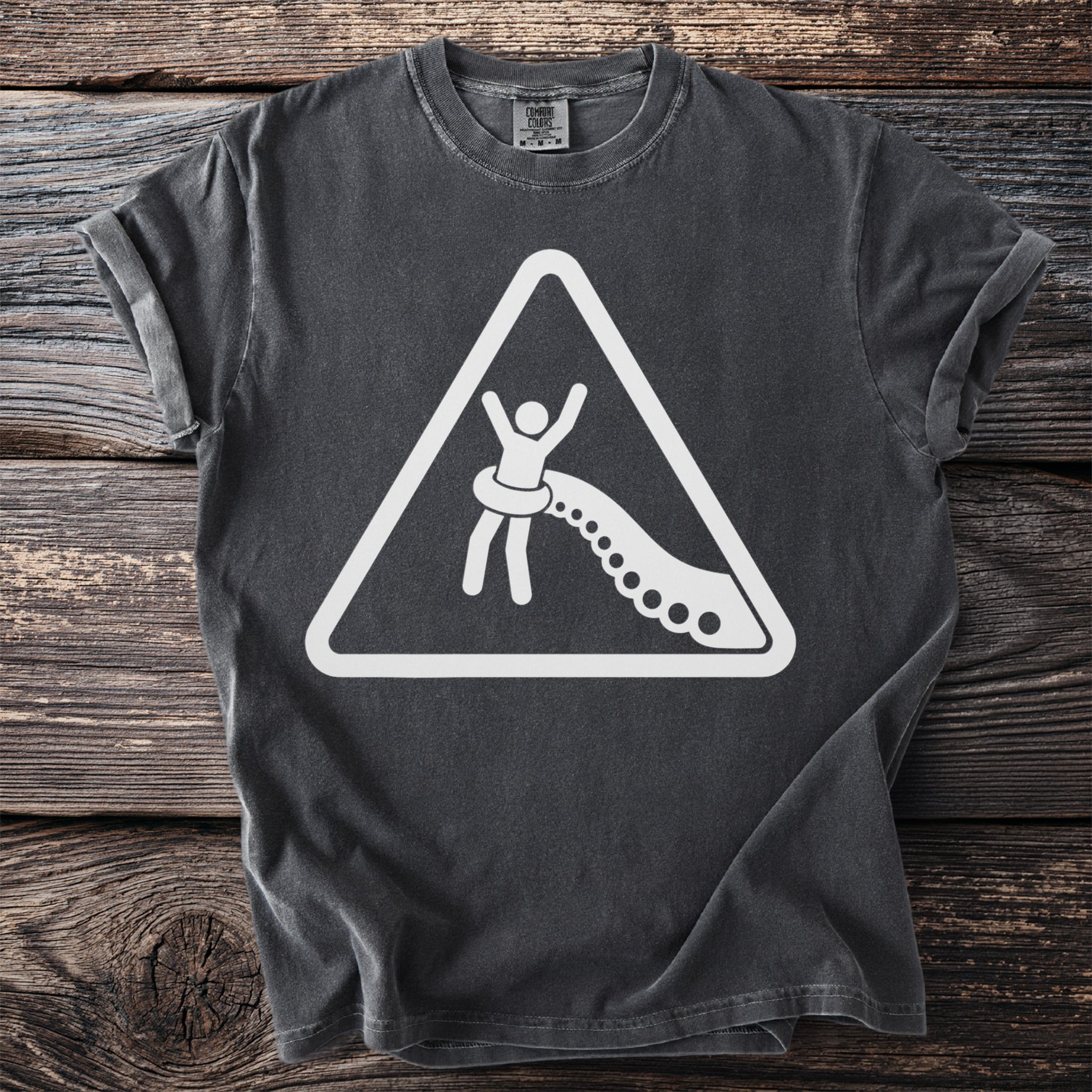 Dark gray t-shirt with a white warning sign graphic of a person being pulled by tentacles.