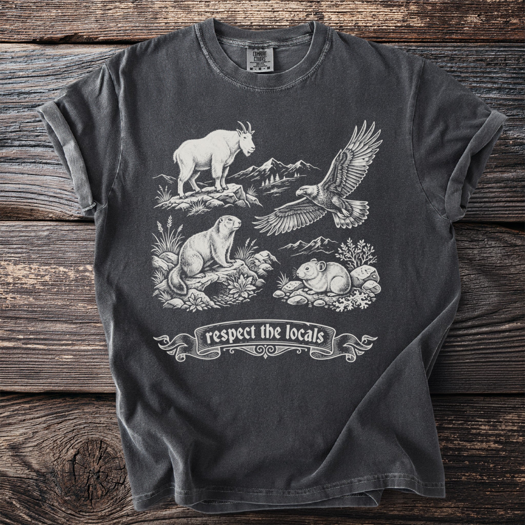 Dark gray t-shirt with a mountain goat, eagle, marmot, and pika graphic and "respect the locals" text.