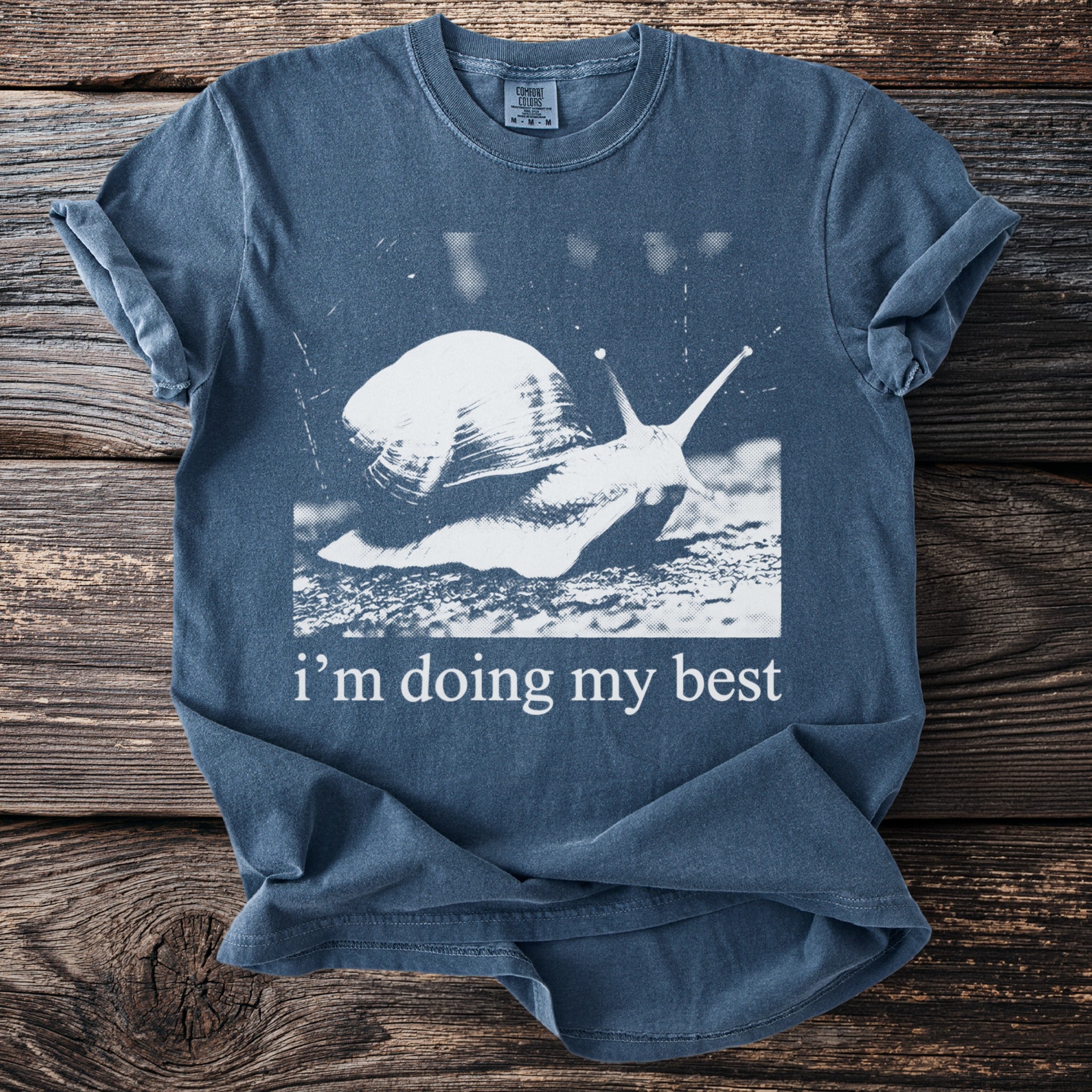 Slate blue t-shirt with a snail graphic and the text "i'm doing my best".