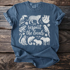 Blue t-shirt with line drawing of jungle animals and text "respect the locals".