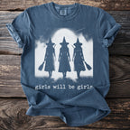 T-shirt with three witch silhouettes holding brooms and the text "girls will be girls".
