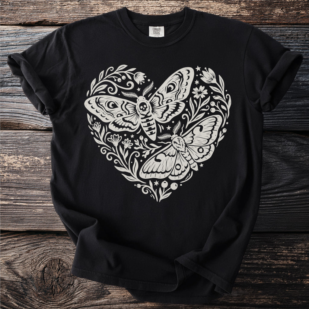 Black t-shirt with cream design of two moths within a heart shape surrounded by flowers.