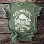 Green t-shirt with white Memento Mori, skull, bones, and hourglass design.