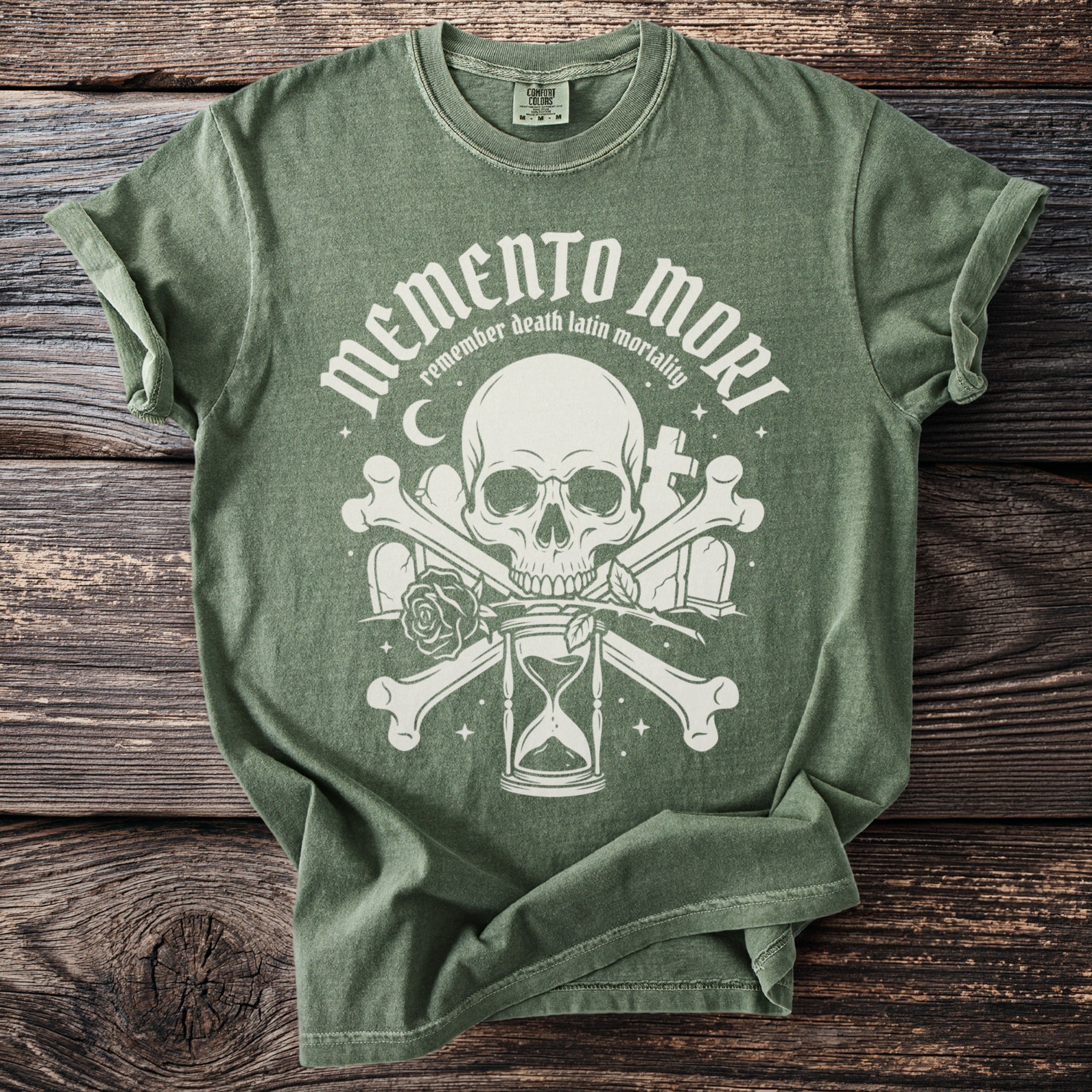 Green t-shirt with white Memento Mori, skull, bones, and hourglass design.