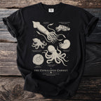 Black t-shirt featuring a scientific illustration of various cephalopods and ammonites.