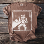 Brown t-shirt with graphic of anthropomorphic wolf at desk saying "this could have been an email."