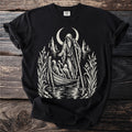 Black t-shirt with a design of a hooded figure in a boat under a crescent moon.