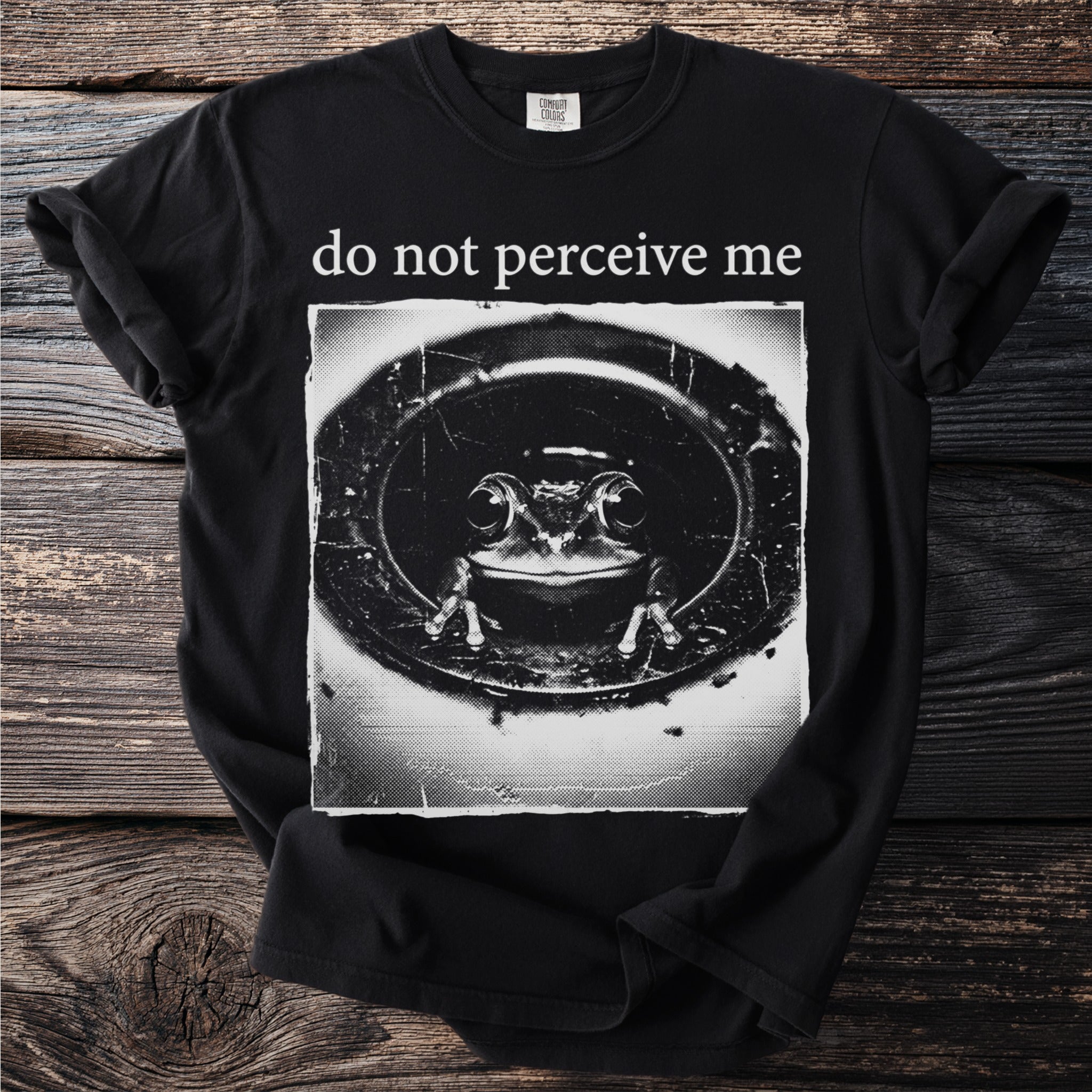 Black t-shirt with a frog in a drain and text "do not perceive me."