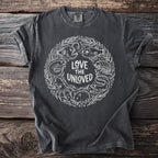 Dark gray t-shirt with white line art featuring sea creatures and "LOVE THE UNLOVED" text.