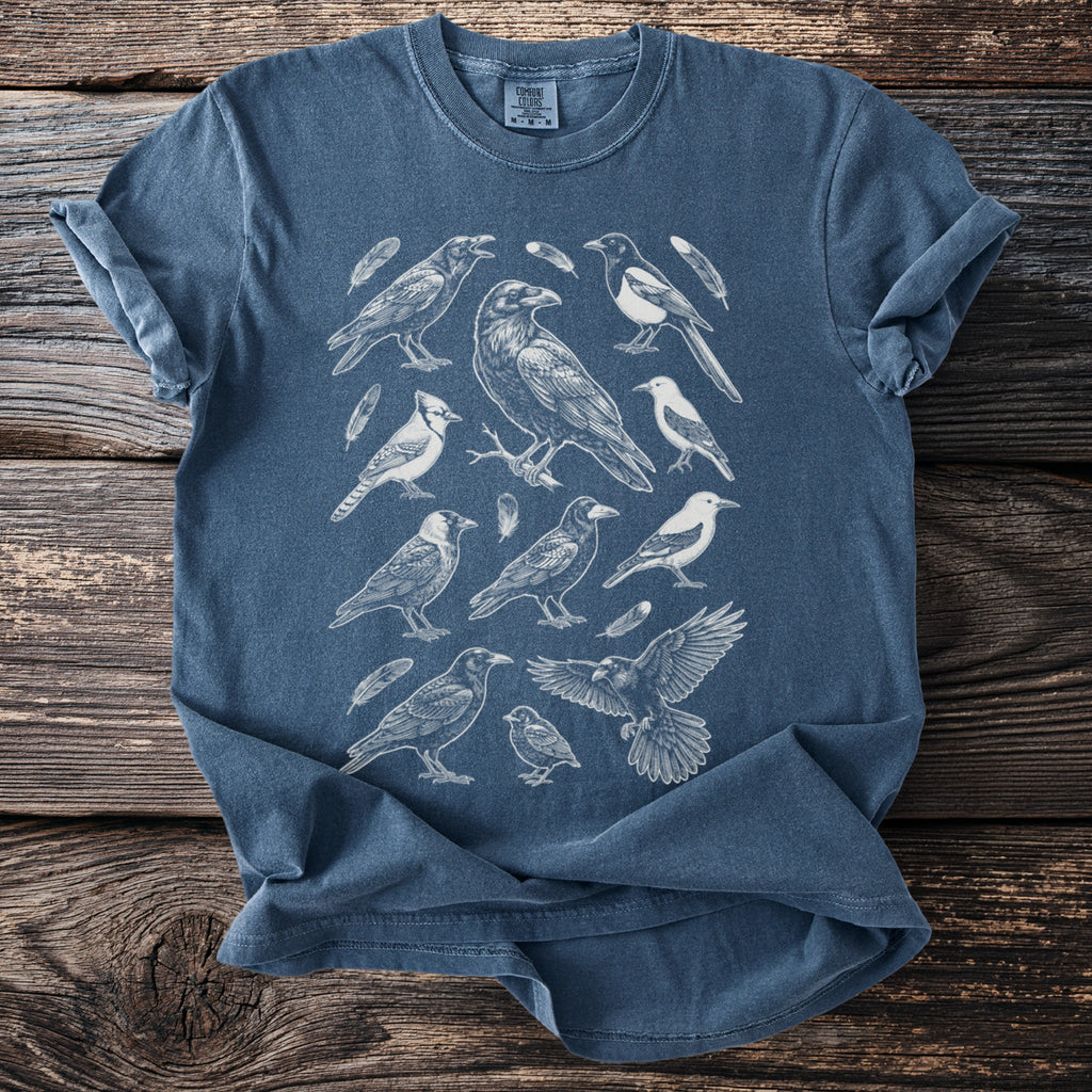 Blue t-shirt featuring a white line art print of various birds and feathers.