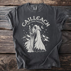 Cailleach celtic winter hag goddess with raven and mountains graphic on a dark gray t-shirt.