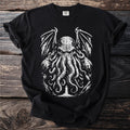 Black t-shirt with a white graphic of a tentacled creature and a lighthouse.