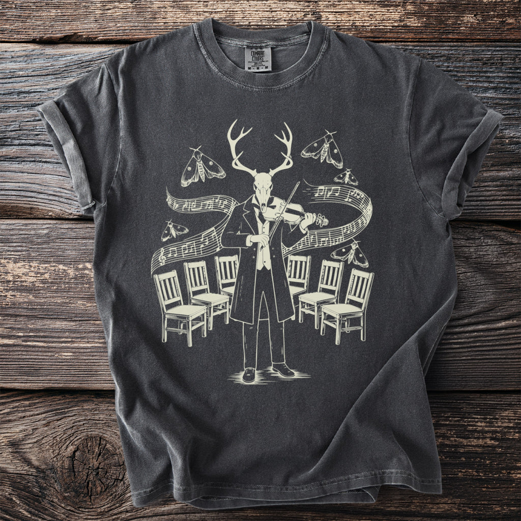 T-shirt with graphic of deer skull in tuxedo playing violin surrounded by moths and chairs.