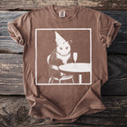 Brown t-shirt with a white graphic of an opossum in a party hat with a champagne flute.