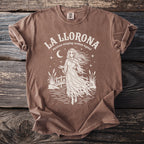 Brown t-shirt with "La Llorona mexican weeping woman legend" text and ghost graphic.