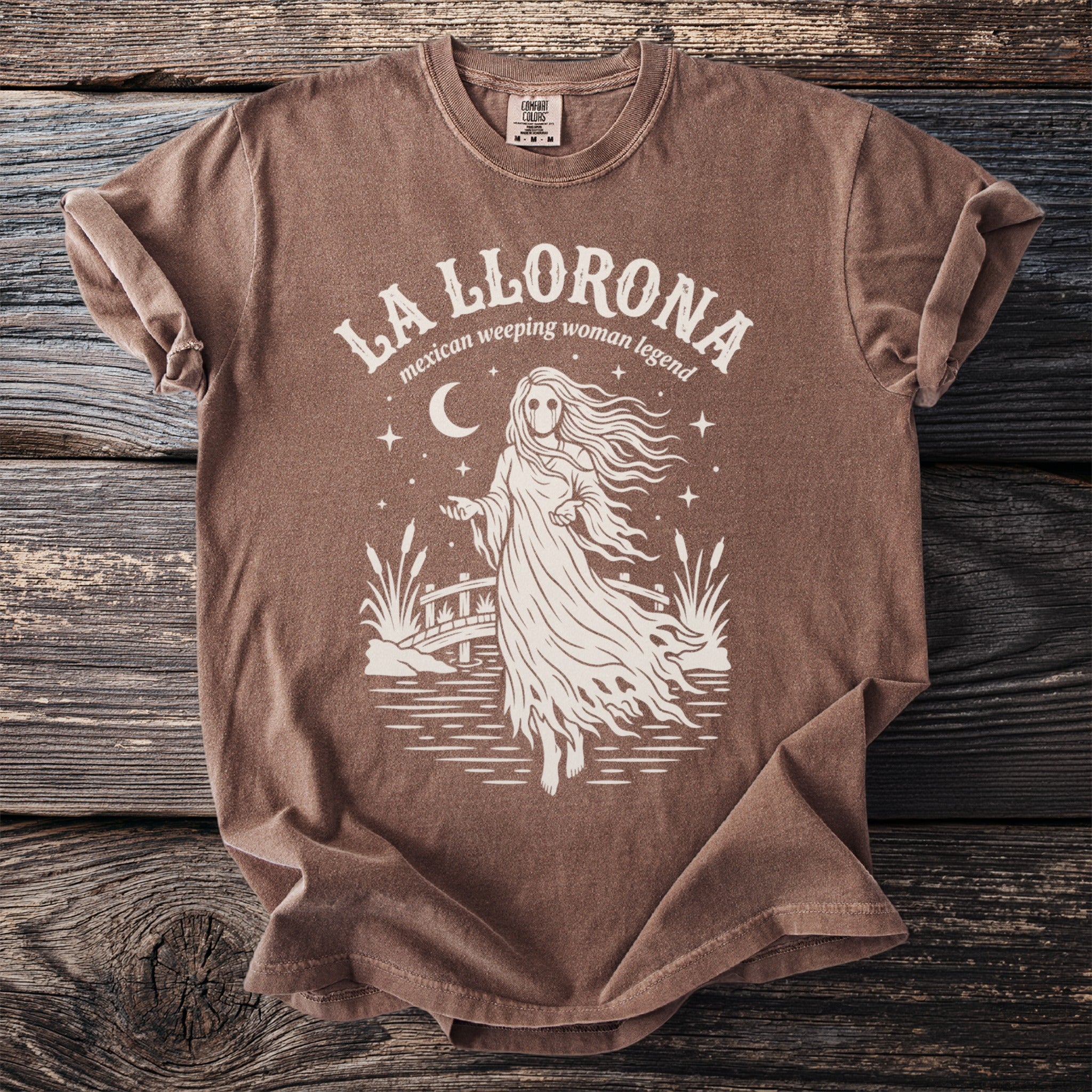 Brown t-shirt with "La Llorona mexican weeping woman legend" text and ghost graphic.