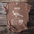 Brown t-shirt featuring a detailed illustration and text about the Hoatzin bird.