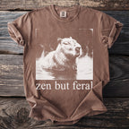 Brown t-shirt with a vintage capybara graphic and text "zen but feral".