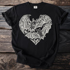 Black t-shirt with a white linocut print of two bats inside a decorative heart shape.