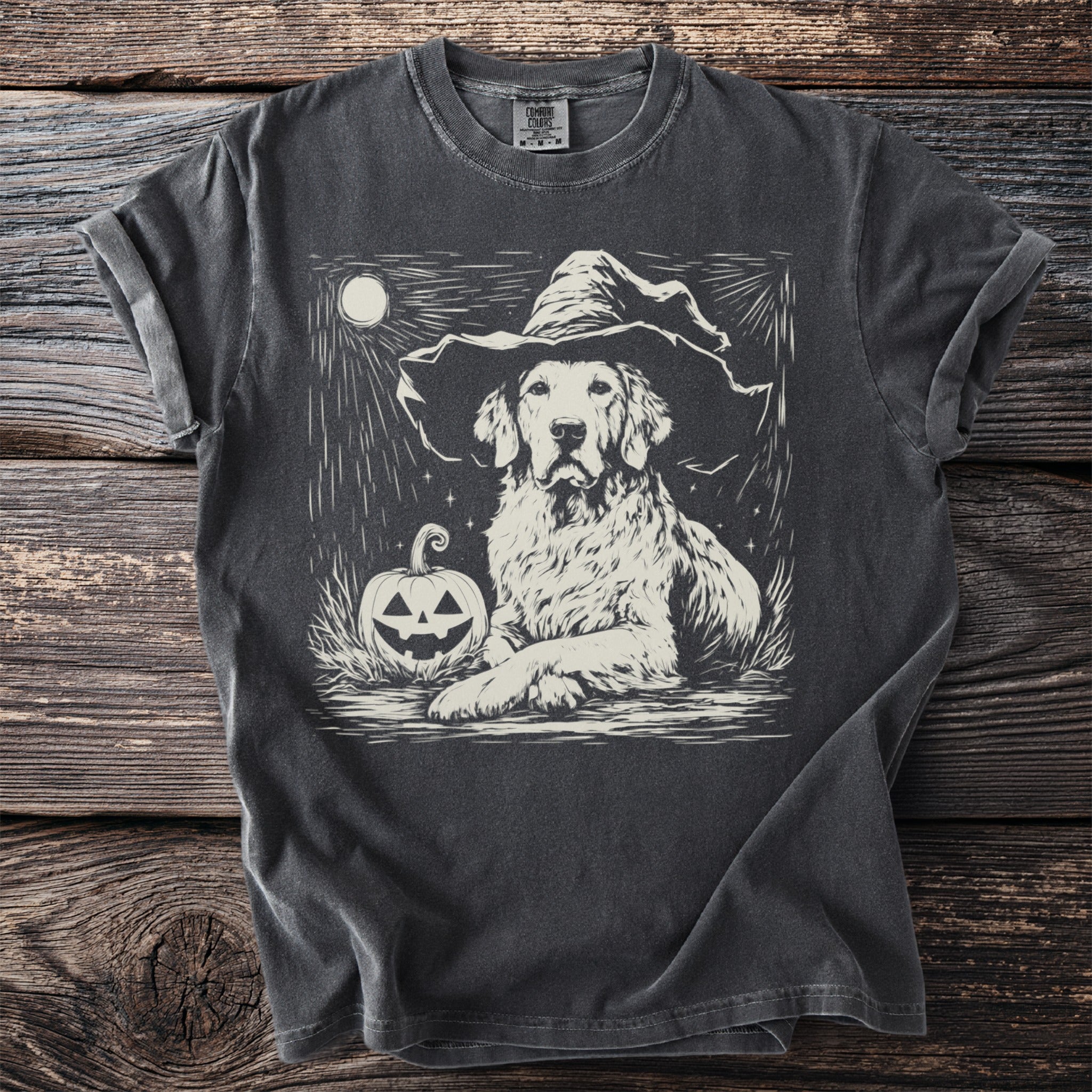 Dark gray t-shirt with a golden retriever in a witch hat beside a pumpkin and moon.
