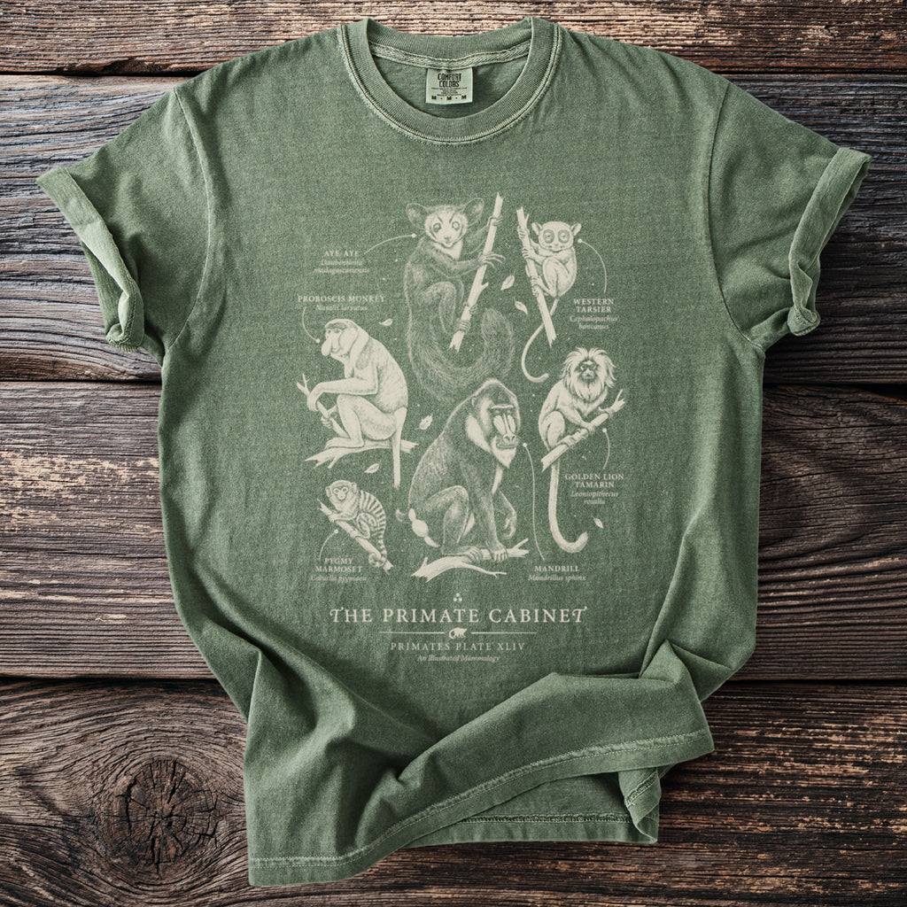 Green t-shirt with "The Primate Cabinet" text and primate illustrations.