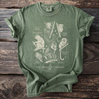 Green t-shirt with "The Primate Cabinet" text and primate illustrations.