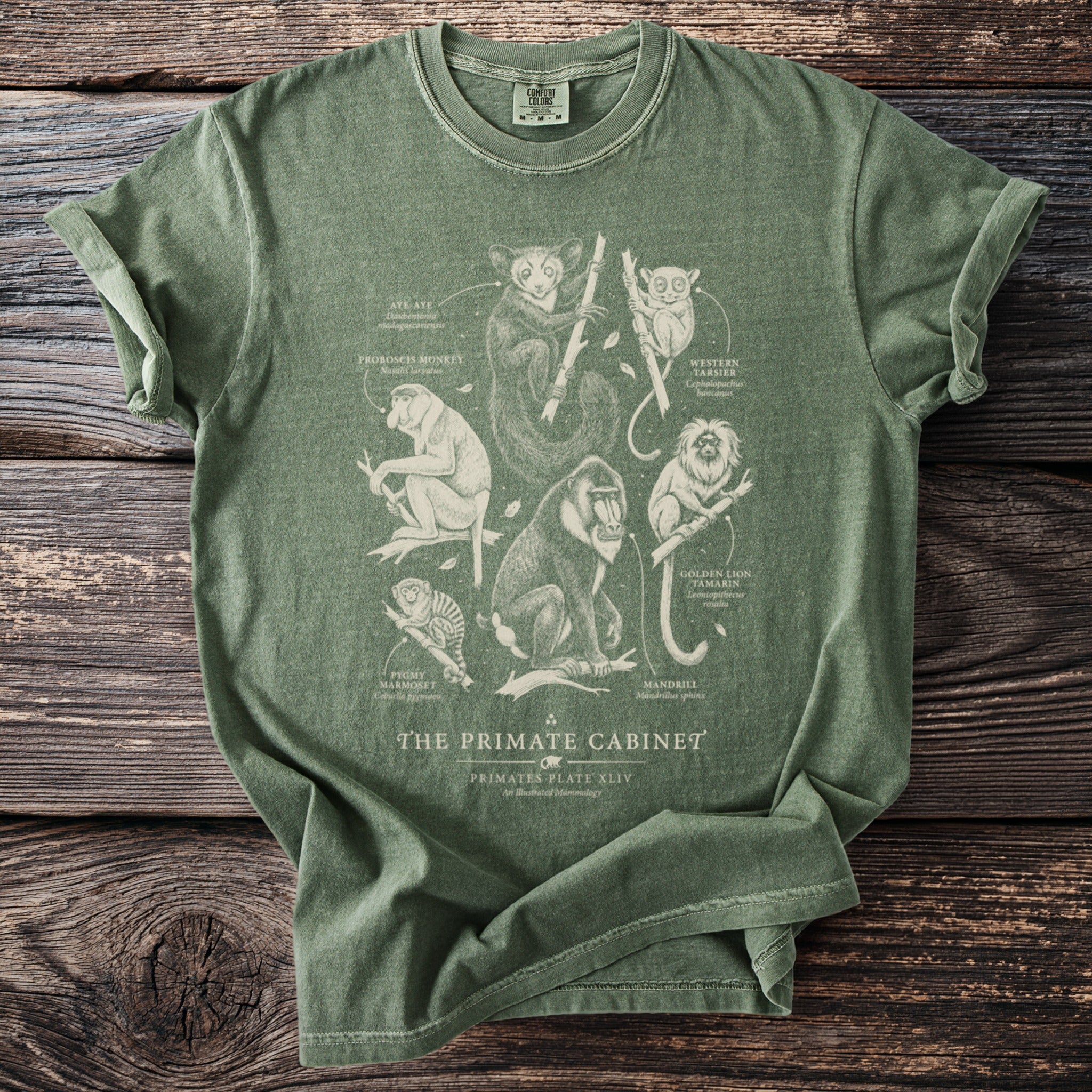 Green t-shirt with "The Primate Cabinet" text and primate illustrations.