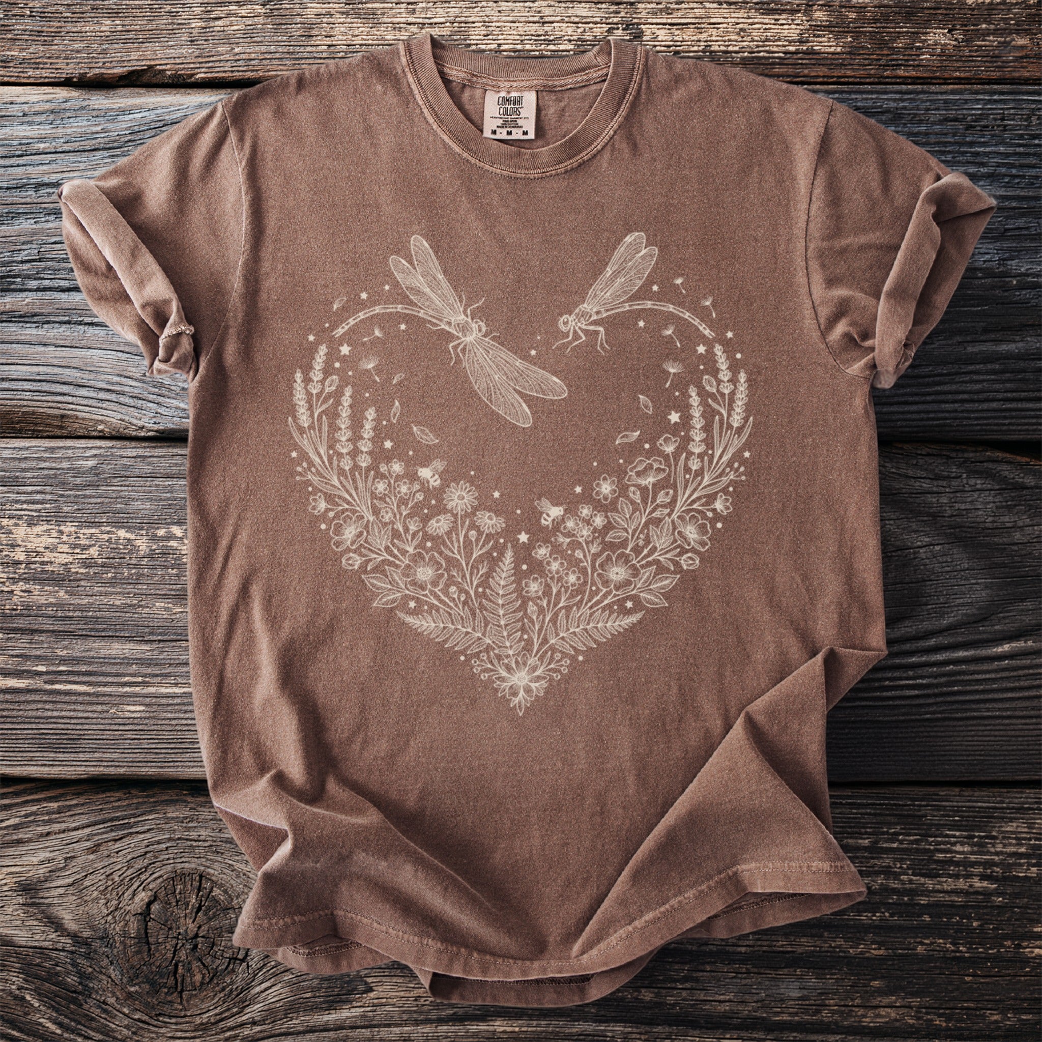 Brown t-shirt with white line art of dragonflies and floral heart.