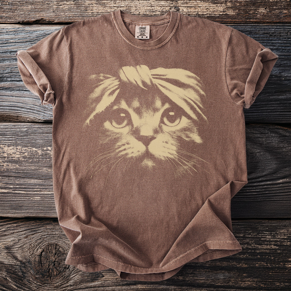Brown t-shirt featuring a light tan graphic of a cat wearing a headband.