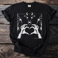 Black t-shirt with graphic of a demon cow with bat wings and hands forming a heart.