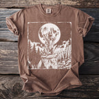 Brown t-shirt with white graphic of raccoon on trash can under full moon.