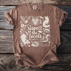 Brown t-shirt with white screen print featuring woodland creatures and the text "respect the locals."