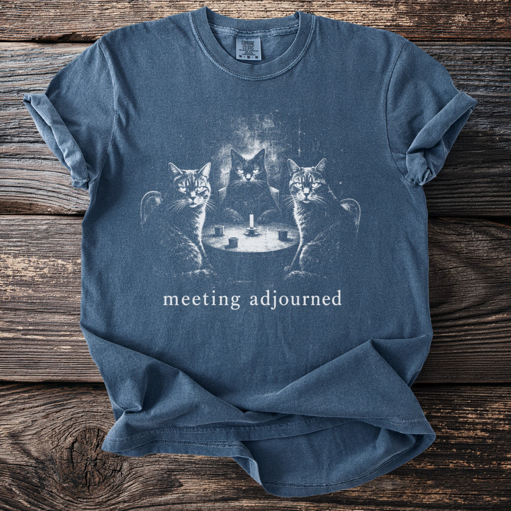 Blue t-shirt with three cats at a table with a candle and text "meeting adjourned".