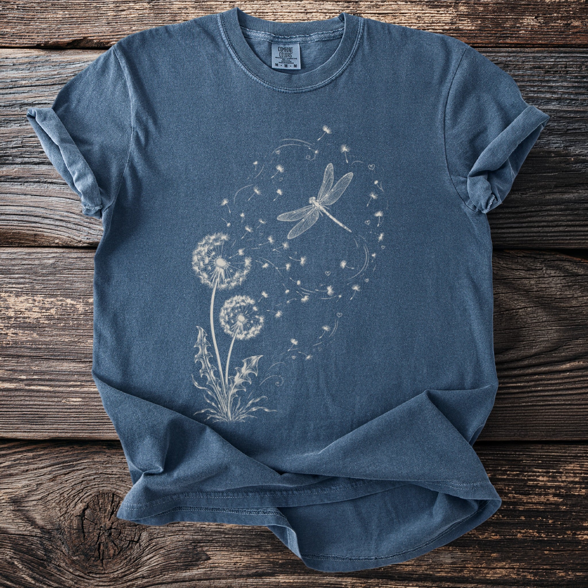 Blue t-shirt with white dragonfly and dandelion print.