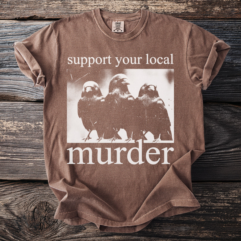 Brown t-shirt with white text and graphic of three birds and the word "murder."
