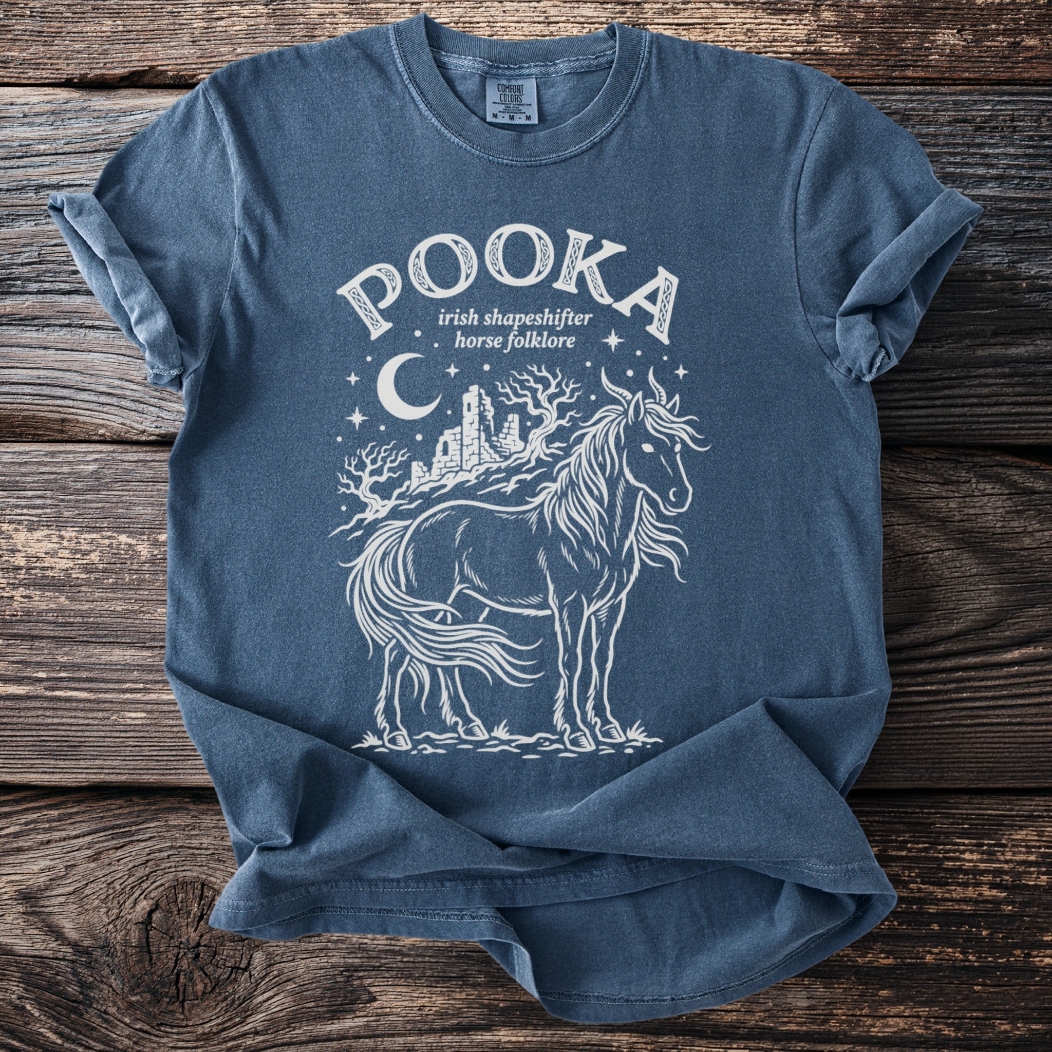 Dark blue t-shirt with white Pooka Irish folklore horse design.