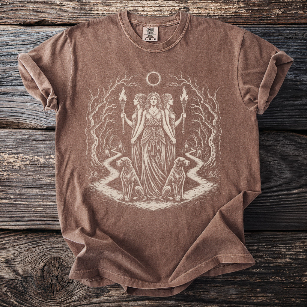 Brown t-shirt with a mystical print of three women holding torches and two dogs.