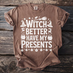 Brown t-shirt with white text "Witch Better Have My Presents" and Halloween graphics.