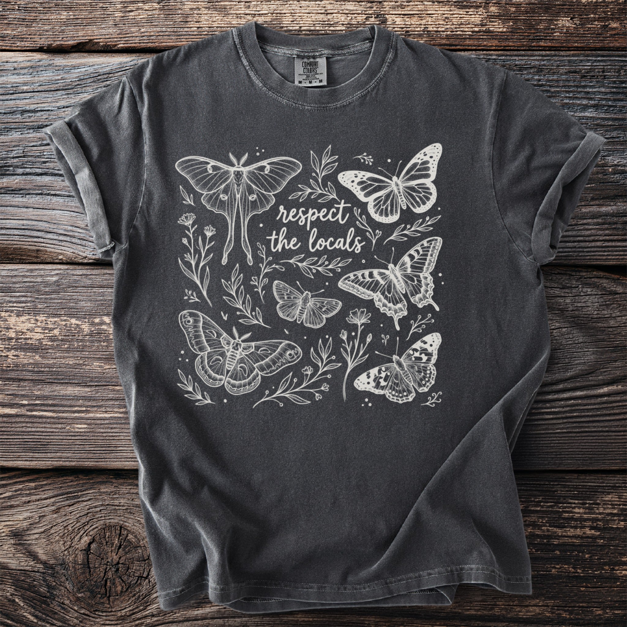 Dark grey t-shirt with moths, butterflies, and "respect the locals" text design.